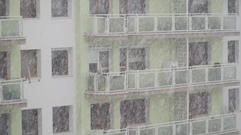 Snowfall with windows at the background Stock Footage 84150945