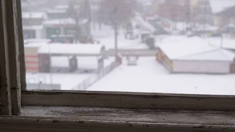 Snowfall in winter. View out of old wooden window Stock Footage 70410567
