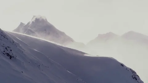 Snowfield With Wind over Massive Jagged Peaks Stock Footage 72840147