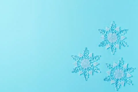 Snowflake on blue background from above. Flat lay, top view. Copy space Stock Photos