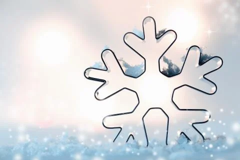 Snowflake cookie cutter in snow Stock Photos
