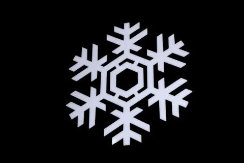 Snowflake isolated on black background: macro photo of real snow crystal, cap Stock Photos