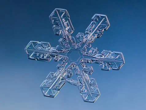 Snowflake on smooth gradient background. Macro photo of real snow crystal on 스톡 사진
