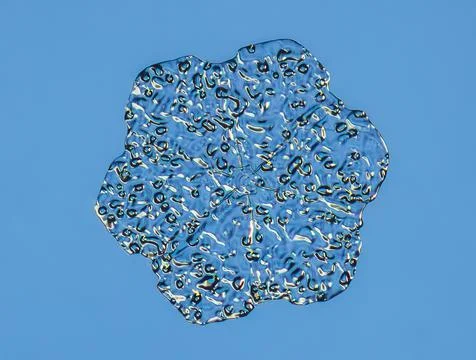 Snowflake on smooth gradient background. Macro photo of real snow crystal on 스톡 사진