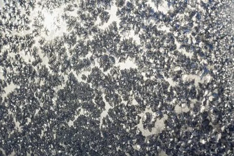 Snowflakes and ice on frozen window Stock Photos