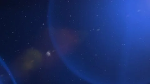 Snowflakes are falling on the background of  luminous rays. Light Leak Stock-Footage 142256984