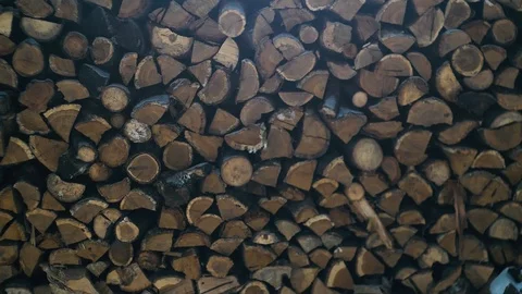 Snowflakes are falling in background of wood heap Stock Footage 86564041
