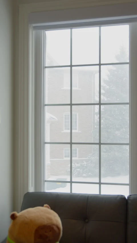 Snowflakes are falling outside the window (vertical video) Stock Footage 329072615