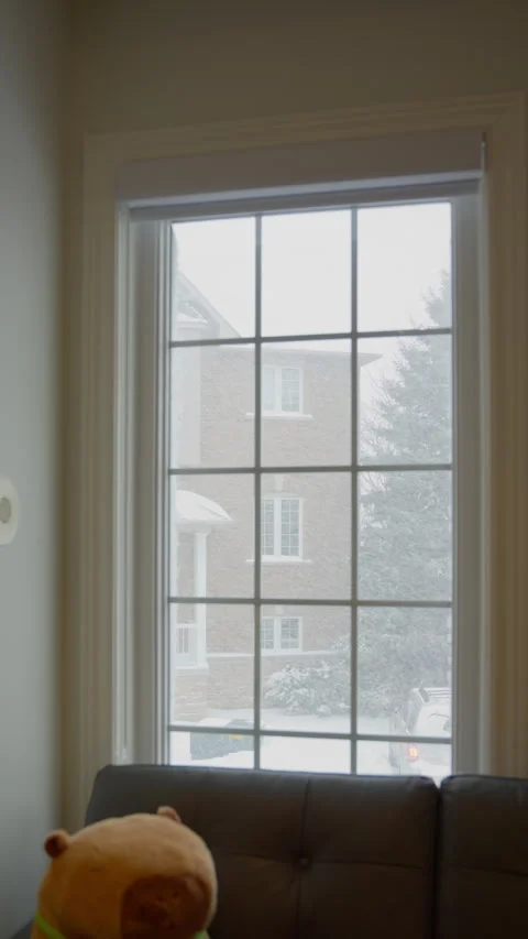 Snowflakes are falling outside the window (vertical video) Stock Footage 329072706