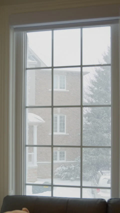 Snowflakes are falling outside the window (vertical video) Stock Footage 329072709