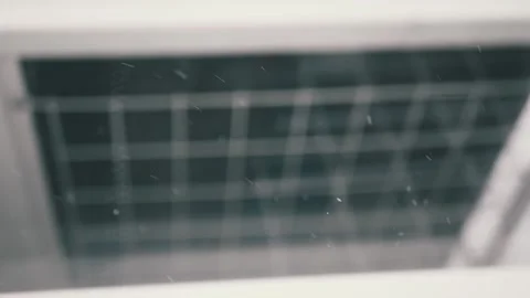 Snowflakes Fall Gently Against Blurry Barred Window 動画素材 327555848