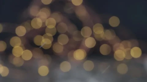 Snowflakes falling and dark bokeh glowing lights background Stock Footage 323847355
