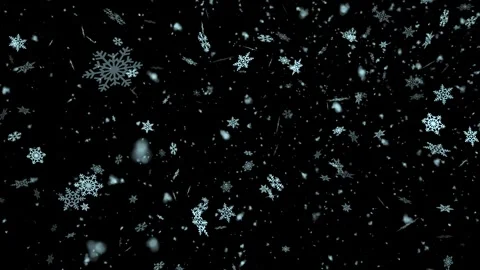 Snowflakes falling on a black background are reminiscent of a starry winter nigh Stock Footage 273982811