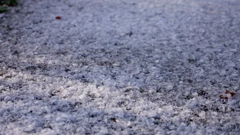 Snowflakes falling on dark asphalt road in close up, 4K Stock Footage 326201686