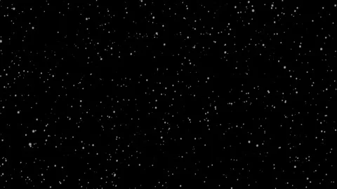 Snowflakes gently in dark winter sky. black background Stock Footage 323110070