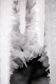 Snowflakes on icicles. Beautiful ice pattern, natural background. Stock Photos