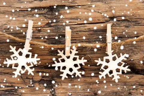 Snowflakes on a Line with Snow on it all over Stock Photos