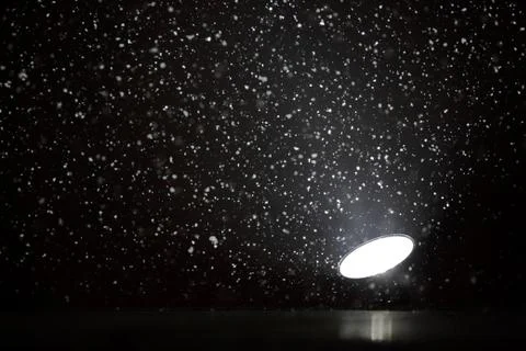 Snowflakes in a projector light Foto stock