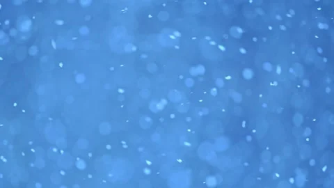 Snowflakes in slow motion create a calm winter bokeh, perfect for holiday themes Stock Footage 295950625