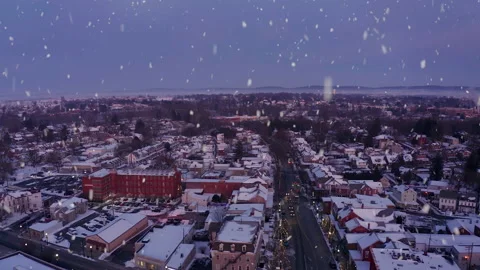 Snowing aerial. Blue hour of town covered in snow at twilight, dusk, dawn. Stock Footage