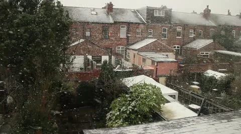 Snowing in back gardens Stock Footage 22302349
