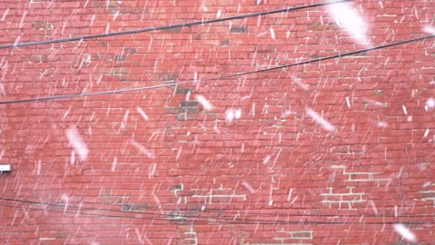 Snowing behind a red bricks wall. 스톡 동영상 133983393