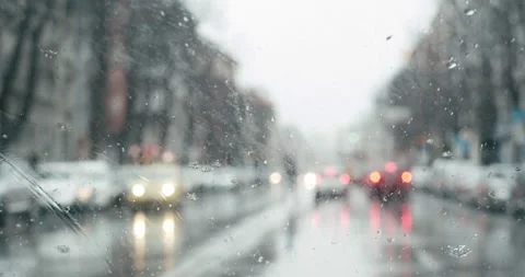 Snowing on car windshield with wipers working while driving Stock-Footage 148489970