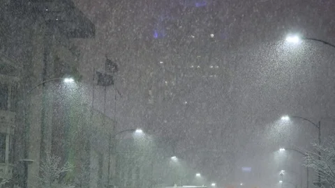 Snowing in city at night Stock Footage 72415804