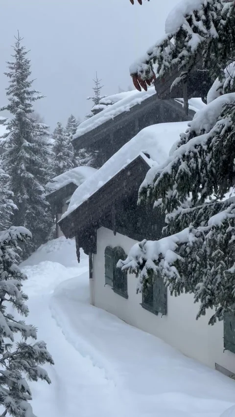 Snowing day in a ski resort with chalets under snow Stock Footage 336966190
