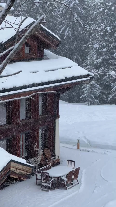 Snowing day in a ski resort with chalets under snow Stock Footage 336966697