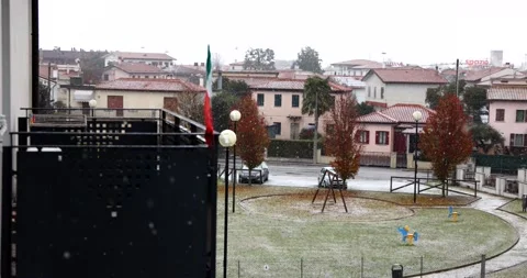 Snowing on an empty playground for children in a calm neighborhood with an it Stock Footage 150203049