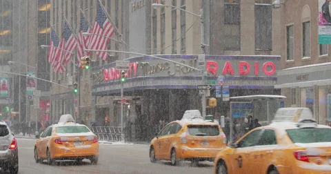 Snowing in New York City street car traffic yellow cabs Stock Footage