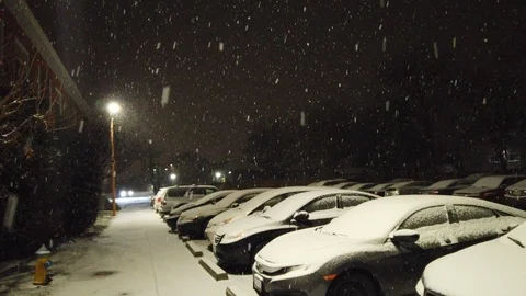 Snowing at night in parking lot Stock Footage 108528264