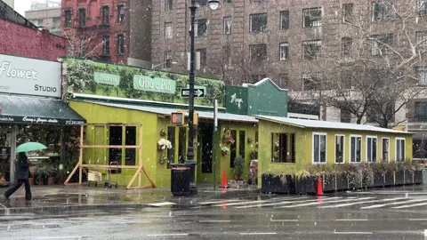 Snowing outdoor dining area in winter New York City NYC 動画素材 147308982