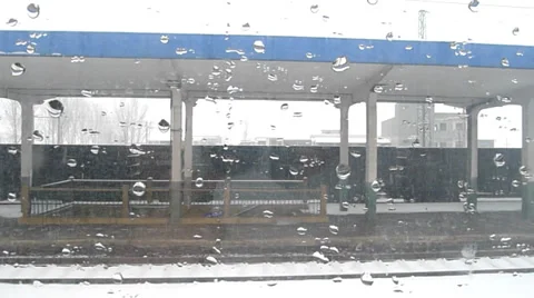 Snowing outside the train window in a railway station Stock Footage 34883076