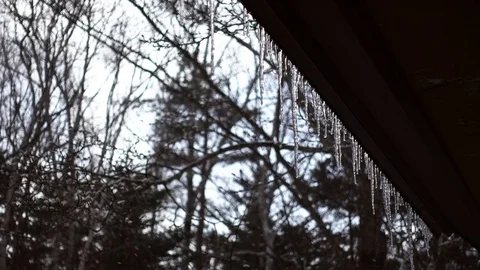 Snowing over Icicle-Hung Eaves Stock-Footage 85352212