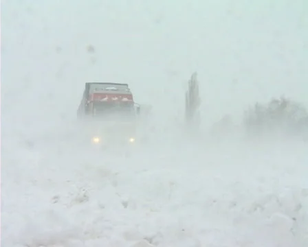 Snowing on road Stock Footage 1100360