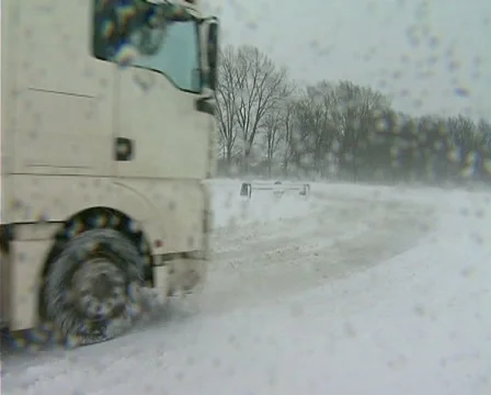 Snowing on road Stock Footage 1100428