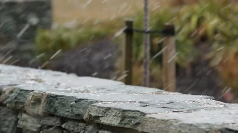 Snowing on rock wall tilting up Stock Footage 52359034