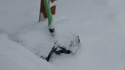Snowing on shovel in backyard Stock Footage 295920141