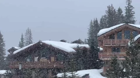 Snowing in a ski resort over beautiful wooden chalets Stock Footage 337054506