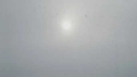 Snowing snow falling in sun cloud fog Stock Footage 148320832