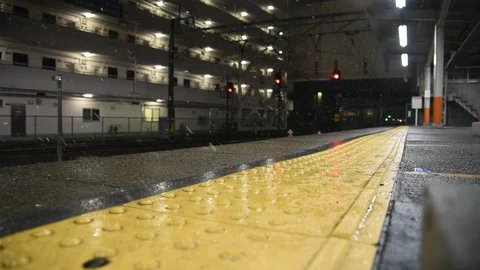 Snowing at train station and yellow walk path. Stock Footage