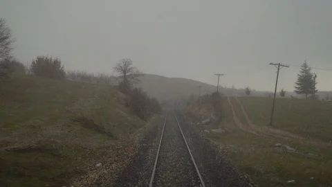 Snowing on train tracks, view from the back of train Stock Footage 107167733