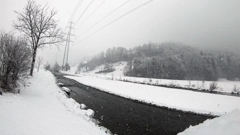 Snowing in the winter with some slow falling snowflakes on a moody day Stock Footage 88435583