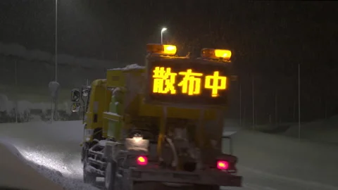 Snowing winter. Spread de-icer on the roads. Move from front to back. Stock Footage 168446247