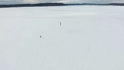 Snowkiting WInter KIteboarding Mountains Backdrop Aerial Drone Stock Footage 172501292