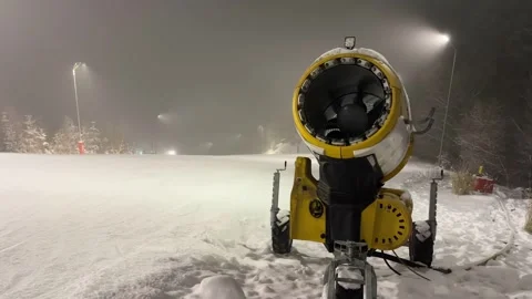 Snowmaking machine operating on ski slope at Gura Humorului on Partia Soimul Stock Footage 328213868