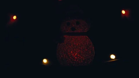 Snowman with blinking light glowing on dark background Stock Footage 118970268