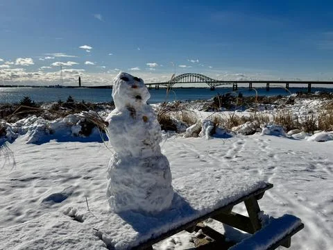 Snowman by the bridge Stock Photos